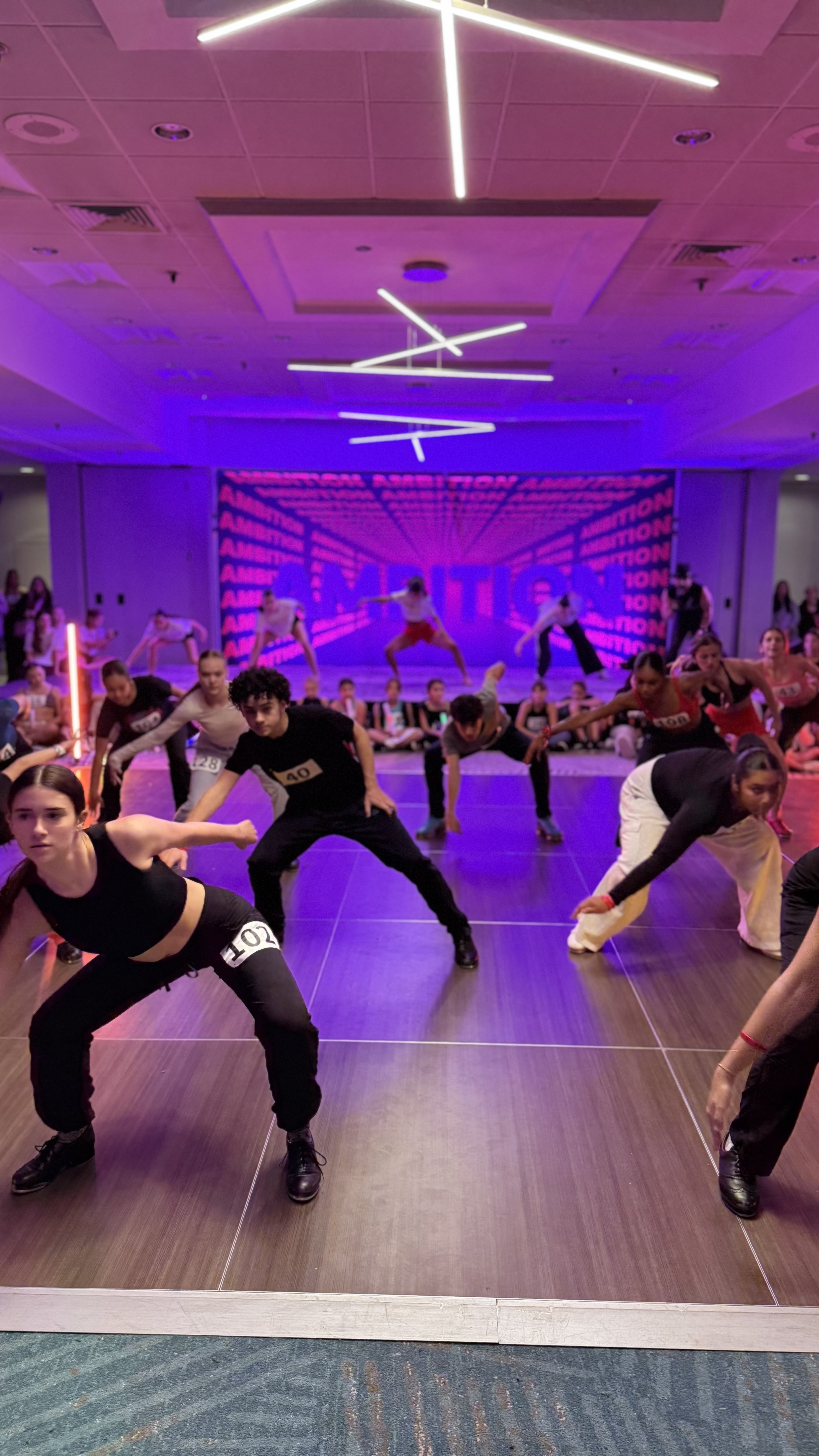 Dancers in class at Ambition with the workshop backdrop